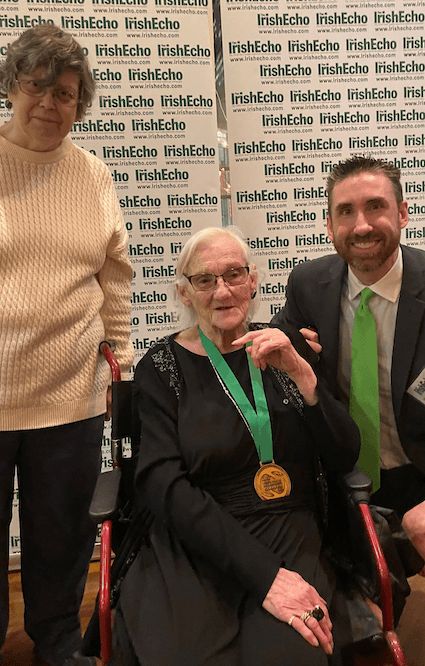 STANDING OVATION: Joan Moody of the Harp & Shamrock Society of San Antonio presents to Michael Caplice and his mum Regina.
