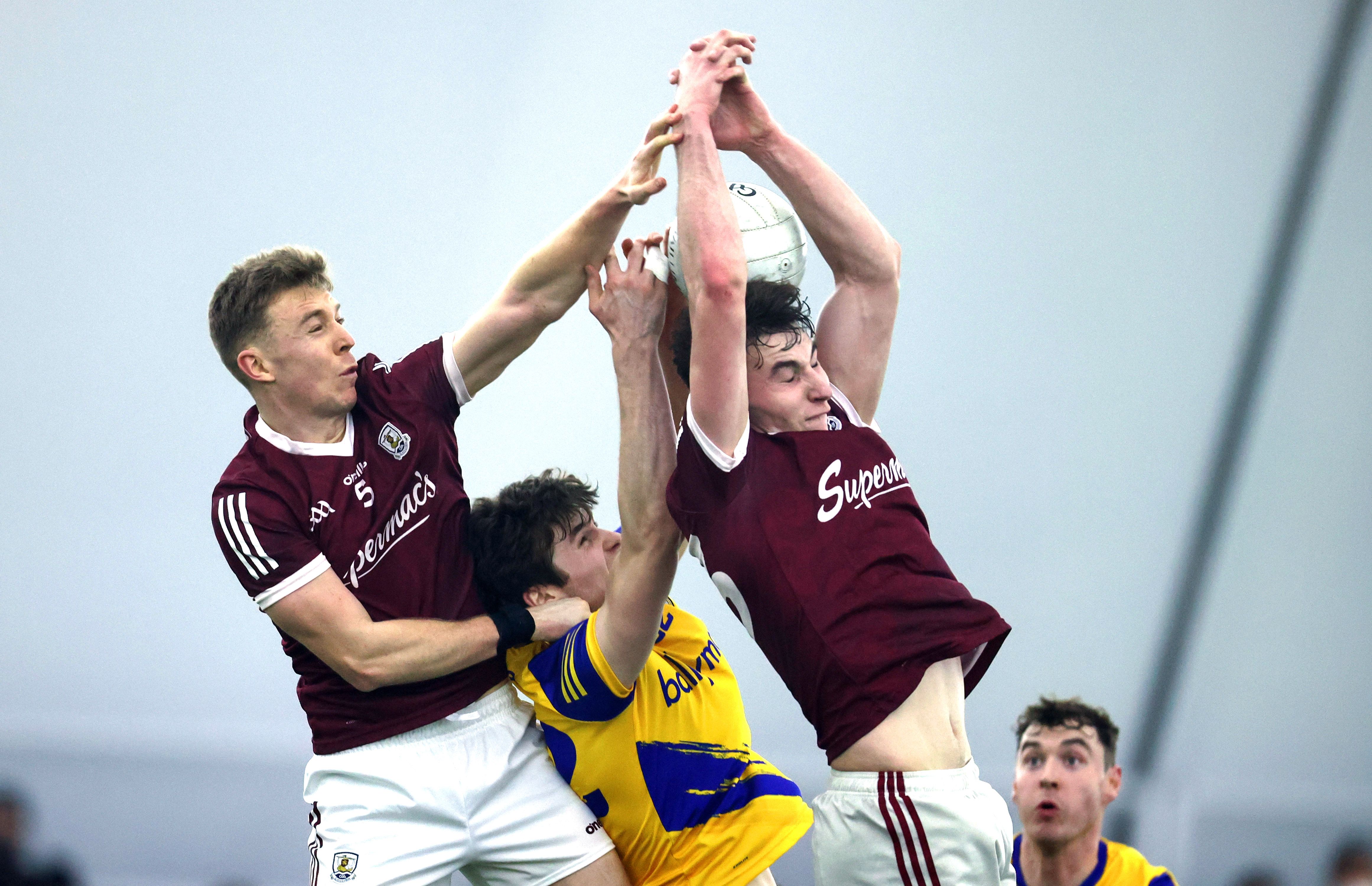 Galway’s Dylan McHugh and Matthew Tierney with Keith Doyle of Roscommon challenge for the ball at the Connacht Air Dome, County Mayo.  INPHO/TOM MAHER
