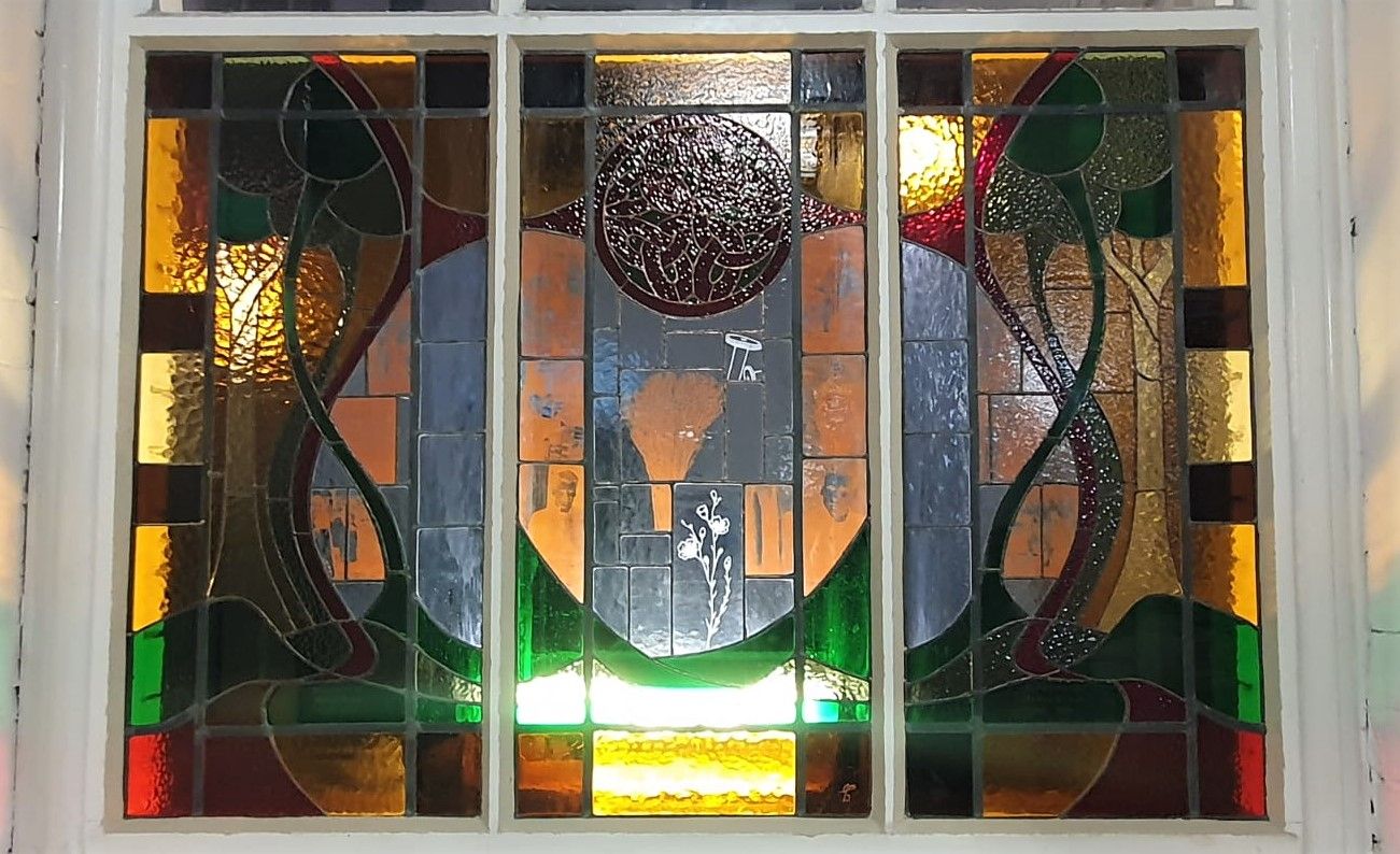 A commemorative stain glass window in Conway Mill.