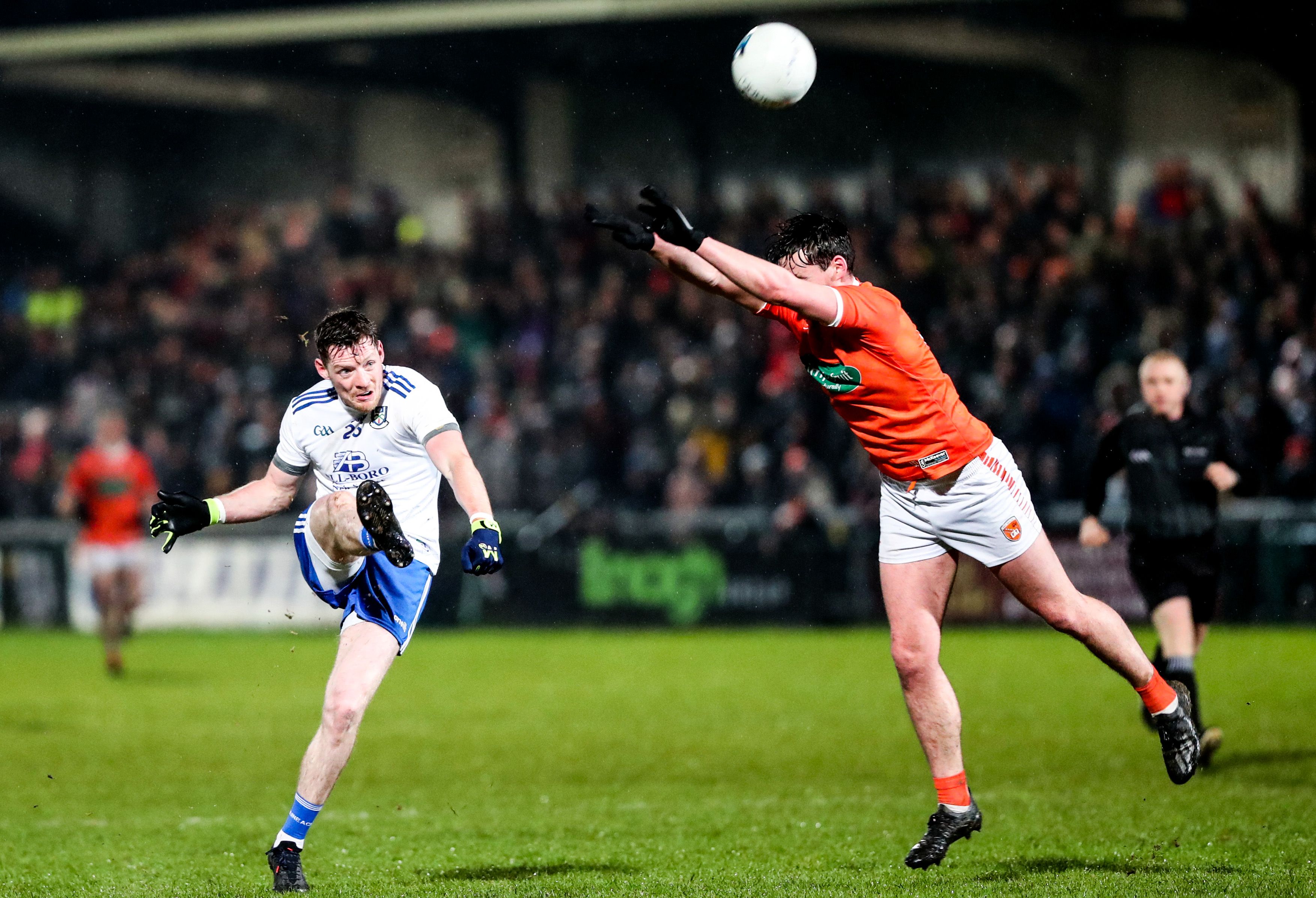 Armagh’s Aaron McKay attempts to block a kick by Conor McManus of Monaghan. INPHO/PHILIP MAGOWAN