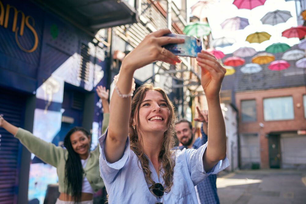 A sunny day under decorative umbrellas in Dublin.