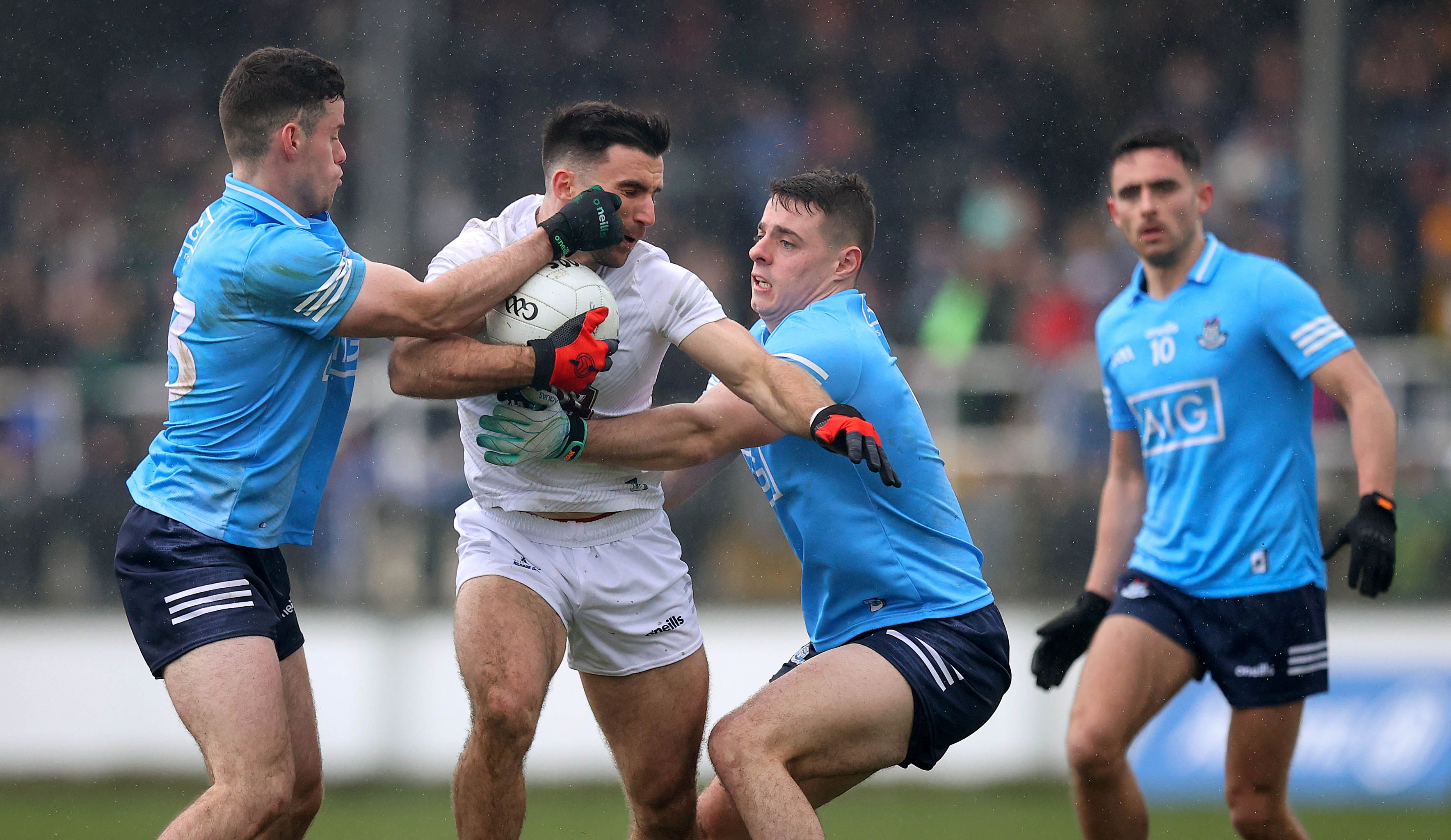 Kildare’s Ryan Houlihan is tackled by Ross McGarry and Brian Howard of Dublin INPHO/RYAN BYRNE