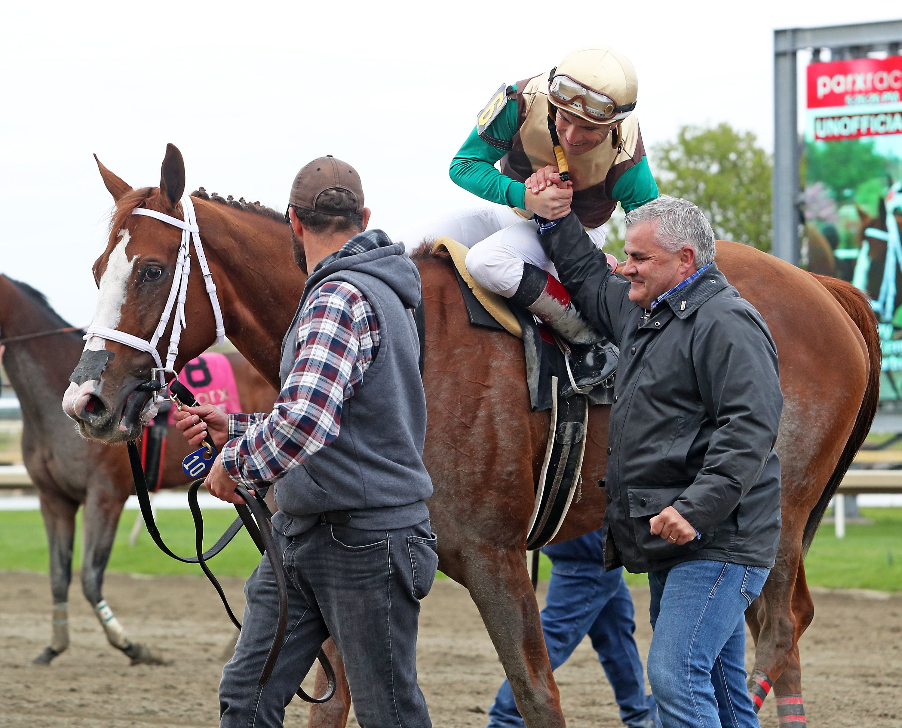 Cathal Lynch congratulates jockey Jorge Ruiz after Cinnabunny's victory in the Unique Bella Stakes at Parx. NIKKI SHERMAN/EQUI-PHOTO