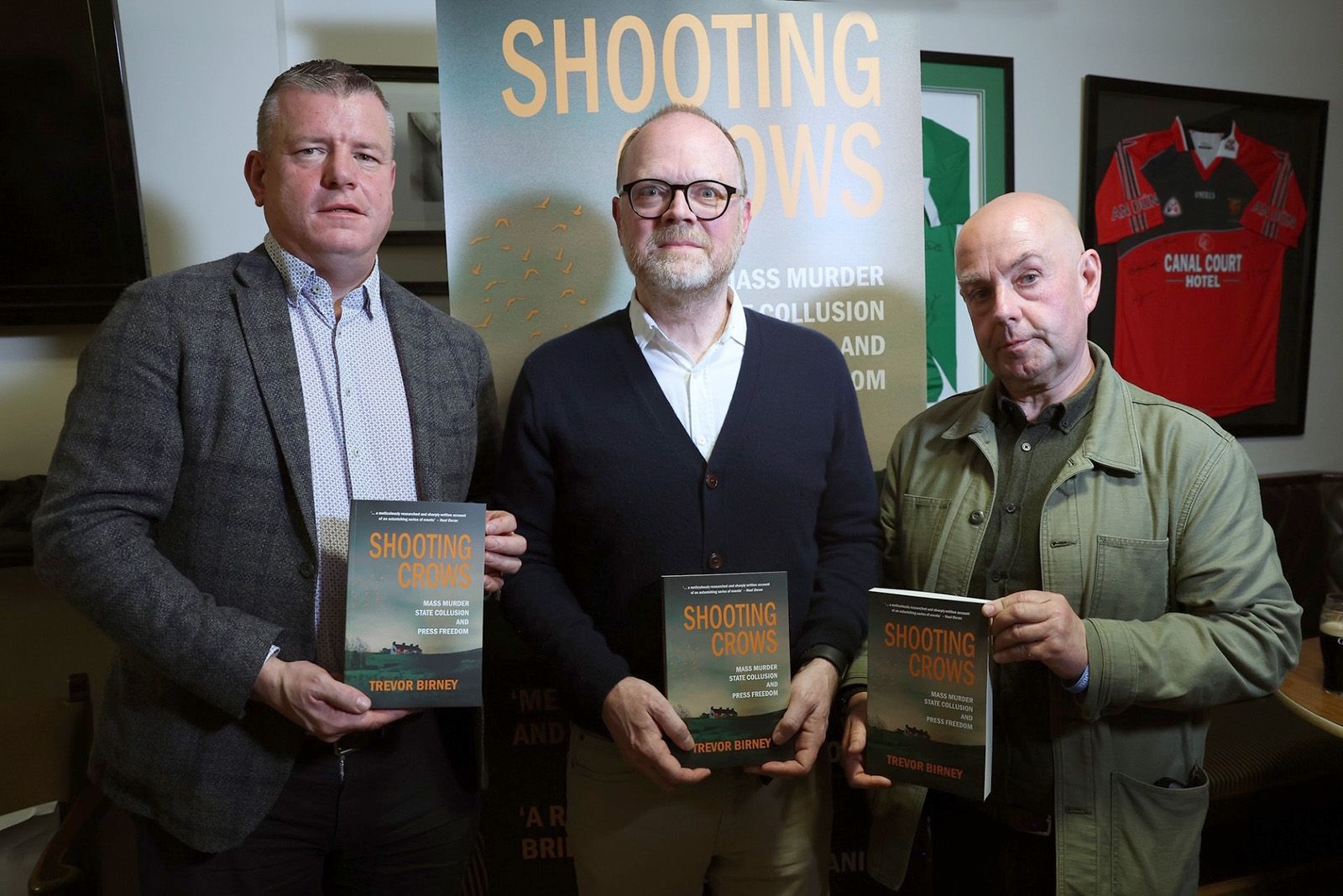 Pictured (l-r) with copies of "Shootings Crows," solicitor Niall Murphy, Trevor Birney and Barry McCaffrey.