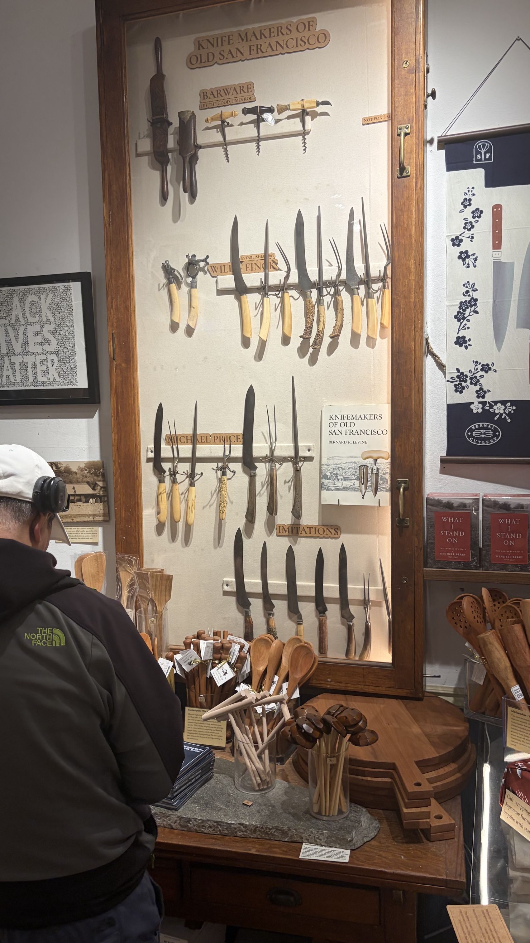 THE PAST IS PROLOGUE: Behind framed glass, a collection of vintage San Francisco knives including the seminal Hugh McConnell creations